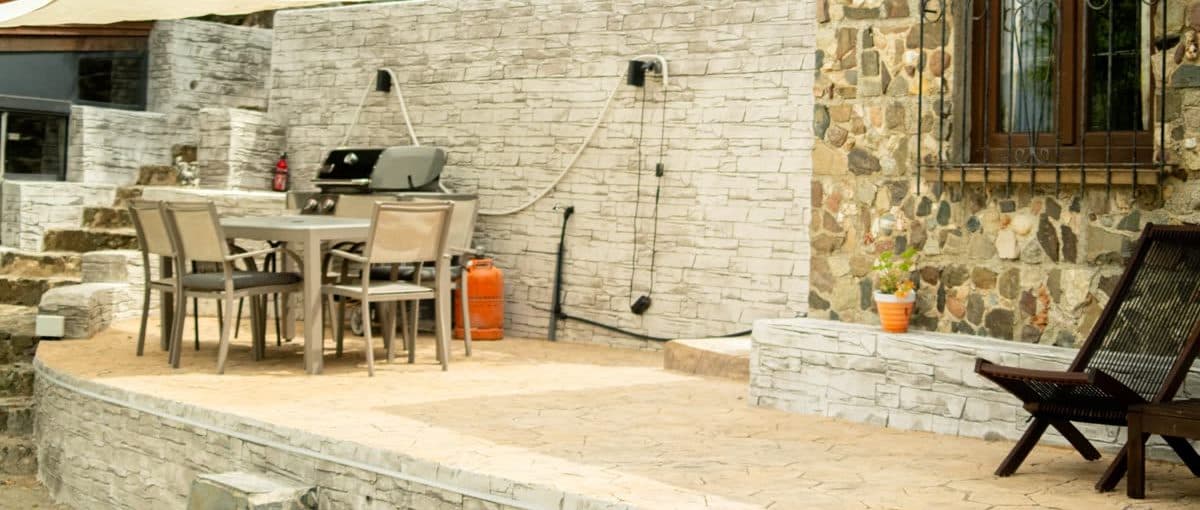 The outdoor dining and barbecue area, shared between the two houses.